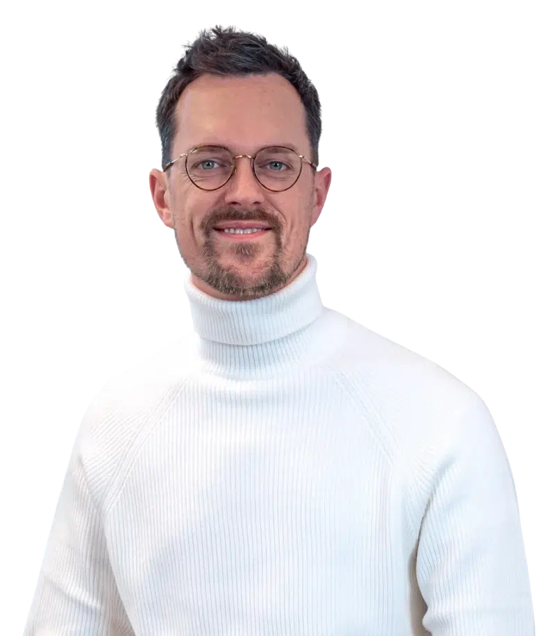 Mann mit Brille und weißem Rollkragenpullover vor transparentem Hintergrund – Experte für Fördermittel & Weiterbildung